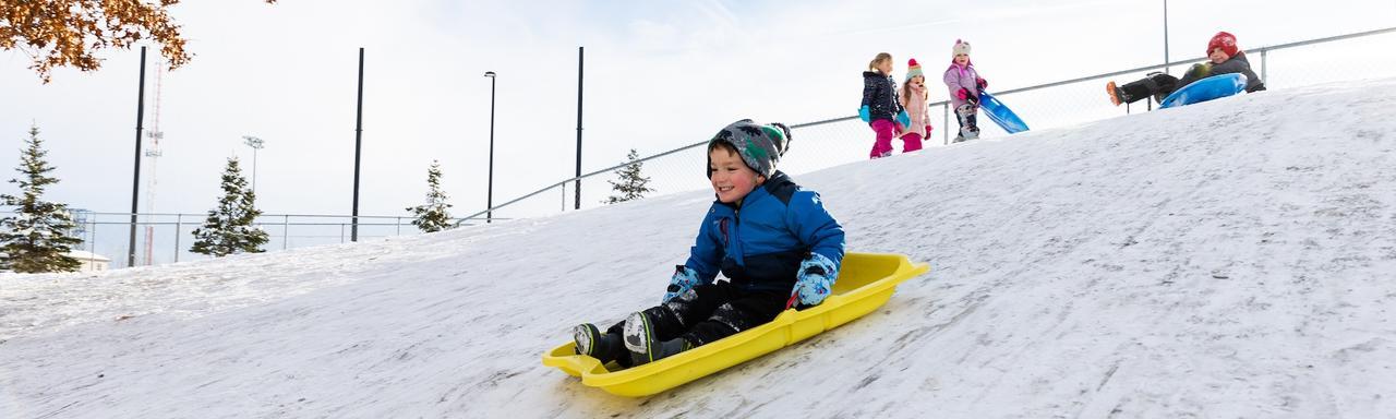 Kids sledding at the Child Enrichment Center at GVSU